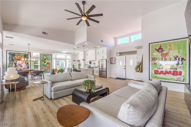 3028 Treesdale Dr, Las Vegas, NV 89134 - living area featuring a high ceiling, a ceiling fan, healthy amount of natural light, and light wood finished floors