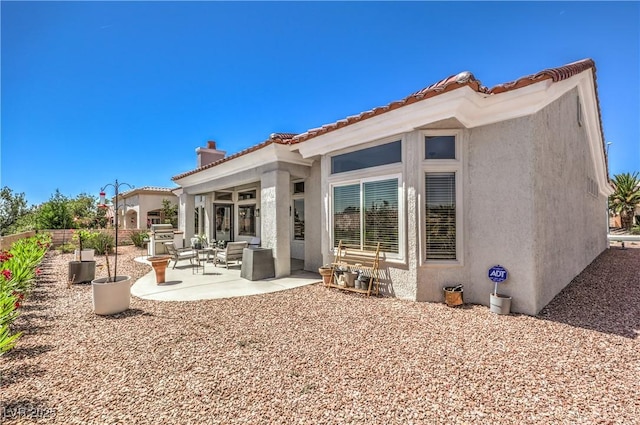 3028 Treesdale Dr, Las Vegas, NV 89134 - rear view of property featuring stucco siding, a patio, a chimney, and a tiled roof