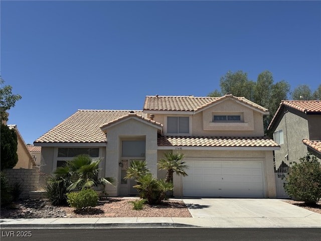 1745 Walingwood Dr, North Las Vegas, NV 89031 - mediterranean / spanish-style house featuring concrete driveway, stucco siding, a tiled roof, and an attached garage