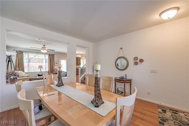 10353 Yew Blossom Ave, Las Vegas, NV 89166 - dining space with light wood-style floors, stairs, baseboards, and a ceiling fan
