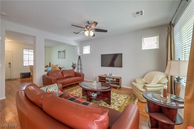 10353 Yew Blossom Ave, Las Vegas, NV 89166 - living area featuring ceiling fan, plenty of natural light, wood finished floors, and baseboards