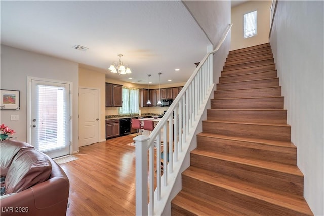 10353 Yew Blossom Ave, Las Vegas, NV 89166 - stairway featuring a chandelier, wood finished floors, and recessed lighting