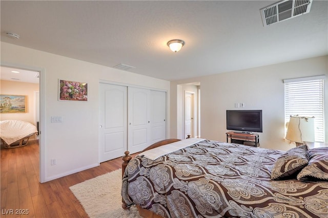 10353 Yew Blossom Ave, Las Vegas, NV 89166 - bedroom with wood finished floors, a closet, and baseboards