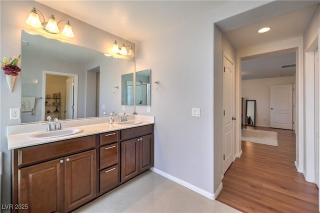 10353 Yew Blossom Ave, Las Vegas, NV 89166 - bathroom with double vanity, baseboards, wood finished floors, and recessed lighting