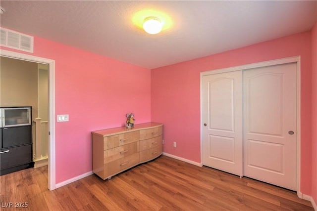 10353 Yew Blossom Ave, Las Vegas, NV 89166 - bedroom with wood finished floors, baseboards, and a closet
