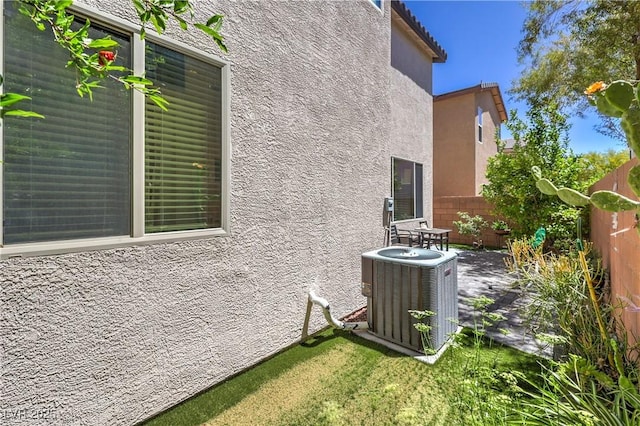 10353 Yew Blossom Ave, Las Vegas, NV 89166 - view of home's exterior featuring stucco siding, cooling unit, and a patio