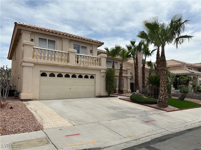 3340 Shallow Pond Dr, Las Vegas, NV 89117 - mediterranean / spanish house with stucco siding, an attached garage, driveway, a tile roof, and a balcony