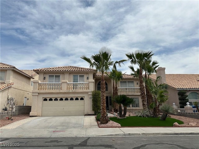3340 Shallow Pond Dr, Las Vegas, NV 89117 - mediterranean / spanish house featuring driveway, stucco siding, a garage, a tile roof, and a balcony