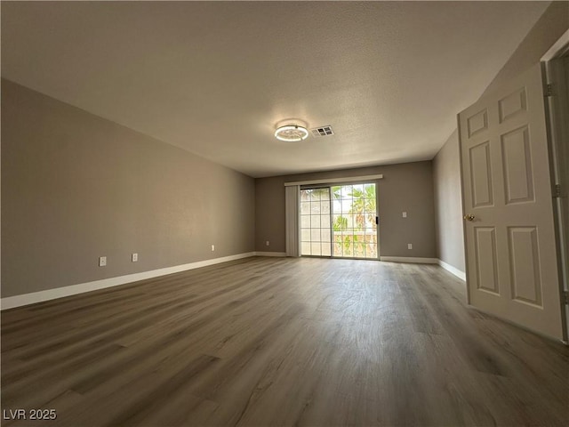 3340 Shallow Pond Dr, Las Vegas, NV 89117 - unfurnished room featuring dark wood-style flooring, baseboards, and a textured ceiling