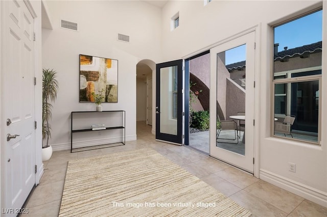 8 Laricola Ct, Henderson, NV 89011 - doorway featuring arched walkways, light tile patterned floors, and baseboards