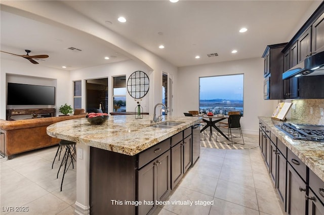 8 Laricola Ct, Henderson, NV 89011 - kitchen featuring a sink, stainless steel appliances, recessed lighting, light tile patterned floors, and light stone counters
