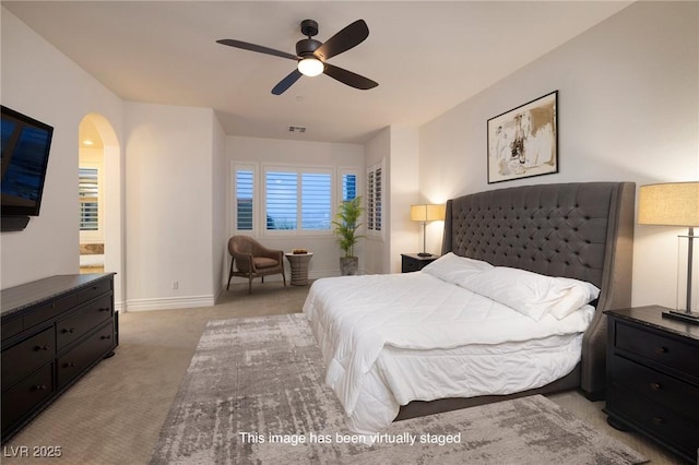 8 Laricola Ct, Henderson, NV 89011 - bedroom featuring light carpet, arched walkways, baseboards, and ceiling fan