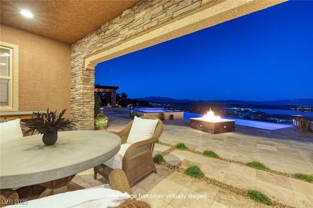 8 Laricola Ct, Henderson, NV 89011 - patio at night with a patio area, outdoor dining area, and an outdoor fire pit