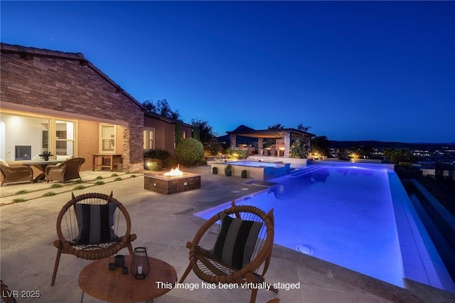 8 Laricola Ct, Henderson, NV 89011 - pool at twilight featuring an outdoor fire pit, a patio, and a pool with connected hot tub