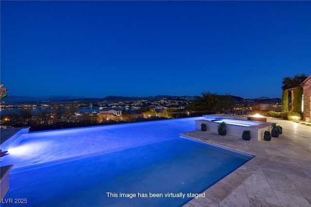 8 Laricola Ct, Henderson, NV 89011 - pool at twilight with an infinity pool, a patio, and an in-ground hot tub