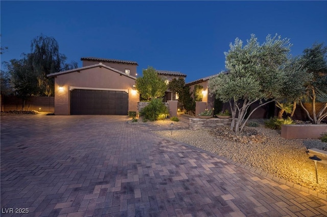 8 Laricola Ct, Henderson, NV 89011 - mediterranean / spanish house featuring a garage, stucco siding, and decorative driveway