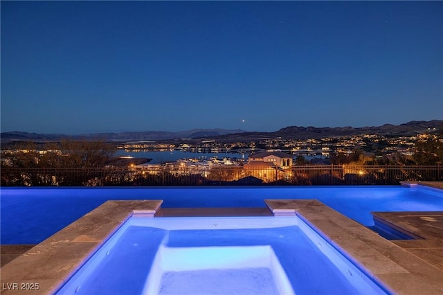 8 Laricola Ct, Henderson, NV 89011 - pool at twilight with an in-ground hot tub and a mountain view