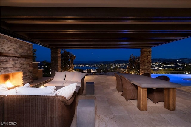 8 Laricola Ct, Henderson, NV 89011 - patio at night with an outdoor living space with a fireplace and a patio