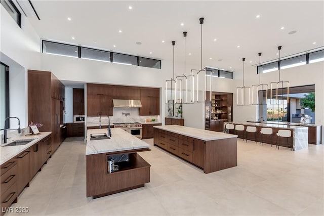 6 Rockmount Ct, Henderson, NV 89012 - kitchen with a spacious island, a towering ceiling, modern cabinets, and a sink