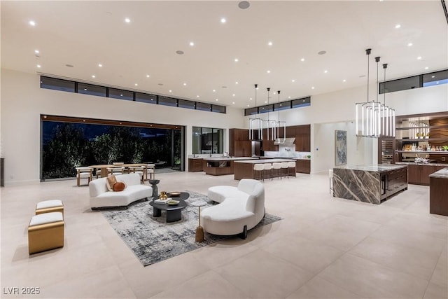 6 Rockmount Ct, Henderson, NV 89012 - living area featuring a towering ceiling, a chandelier, and recessed lighting