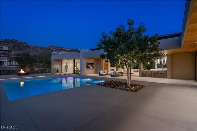 6 Rockmount Ct, Henderson, NV 89012 - pool at twilight with area for grilling, a patio, an outdoor pool, and an outdoor living space with a fire pit
