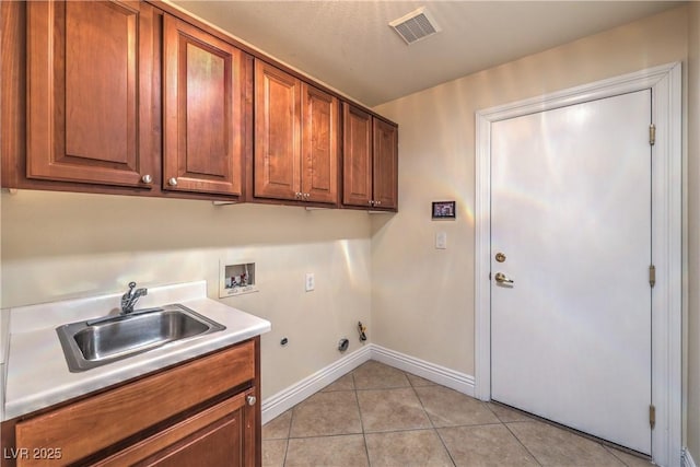 1044 Spanish Needle St, Henderson, NV 89002 - laundry room with gas dryer hookup, washer hookup, light tile patterned floors, cabinet space, and baseboards