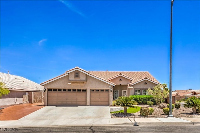1044 Spanish Needle St, Henderson, NV 89002 - view of front of house with stucco siding, a tile roof, an attached garage, and concrete driveway
