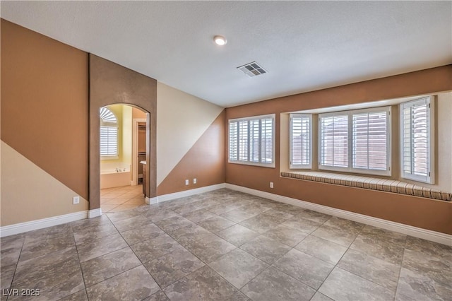 1044 Spanish Needle St, Henderson, NV 89002 - spare room with arched walkways and baseboards