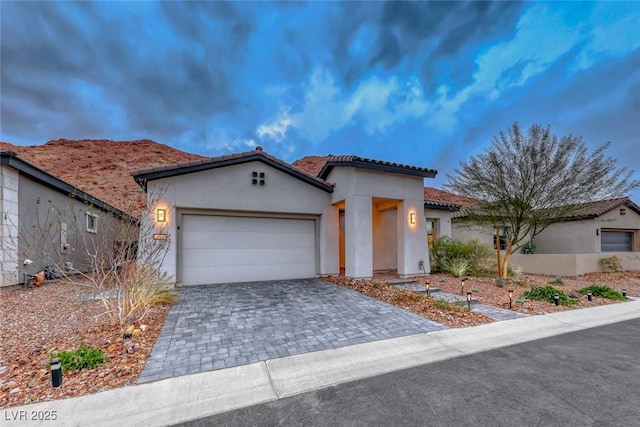 101 Mirage View Dr, Henderson, NV 89011 - view of front of house featuring stucco siding, an attached garage, decorative driveway, and a tile roof