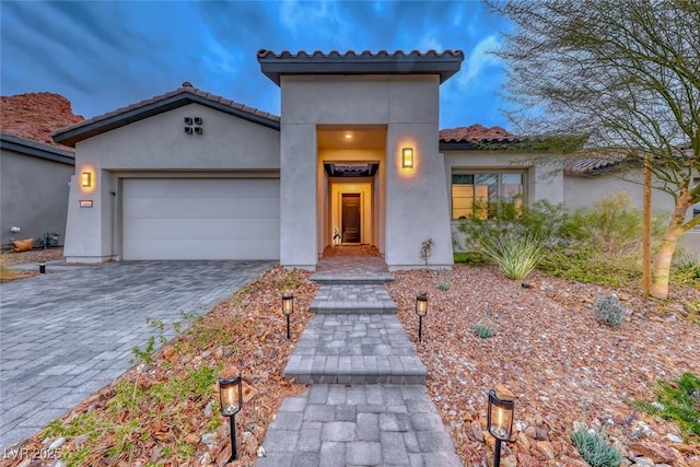 101 Mirage View Dr, Henderson, NV 89011 - view of front facade featuring an attached garage, a tile roof, stucco siding, and decorative driveway
