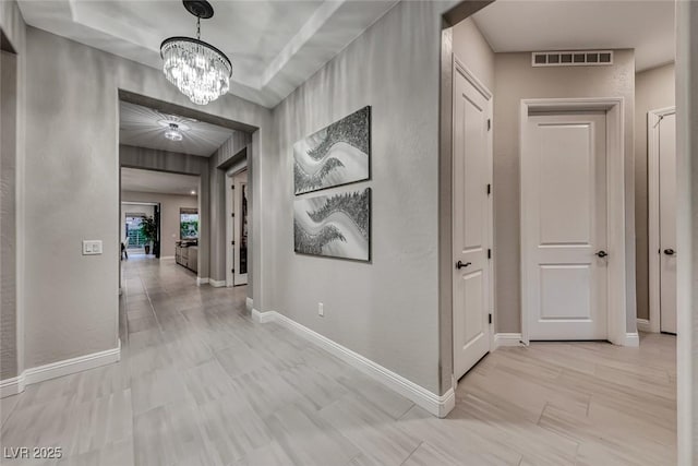 101 Mirage View Dr, Henderson, NV 89011 - hallway featuring a chandelier and baseboards