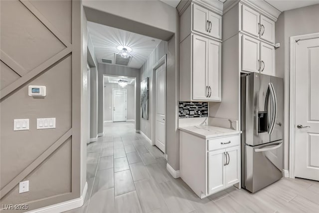 101 Mirage View Dr, Henderson, NV 89011 - kitchen featuring stainless steel fridge, light stone countertops, baseboards, and backsplash