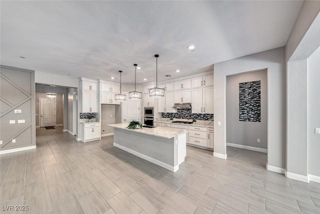101 Mirage View Dr, Henderson, NV 89011 - kitchen featuring appliances with stainless steel finishes, backsplash, under cabinet range hood, white cabinetry, and recessed lighting