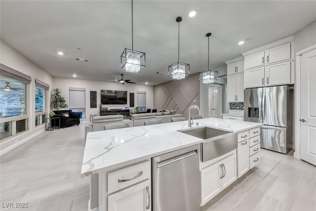 101 Mirage View Dr, Henderson, NV 89011 - kitchen featuring appliances with stainless steel finishes, a sink, ceiling fan, hanging light fixtures, and white cabinetry