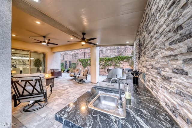101 Mirage View Dr, Henderson, NV 89011 - view of patio / terrace with a sink, an outdoor fire pit, a ceiling fan, and area for grilling
