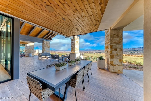 101 Mirage View Dr, Henderson, NV 89011 - wooden terrace featuring outdoor dining space, a patio, and a mountain view