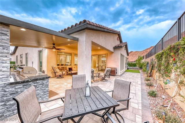 101 Mirage View Dr, Henderson, NV 89011 - view of patio with exterior kitchen, outdoor dining space, and a ceiling fan