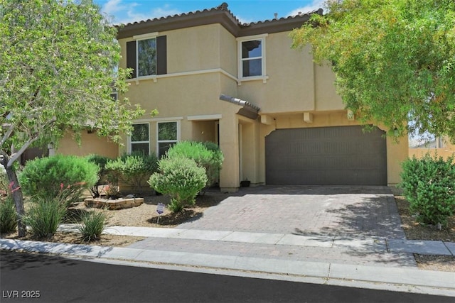 2117 Leatherbridge Ct, North Las Vegas, NV 89081 - view of front of house with a garage, stucco siding, and driveway