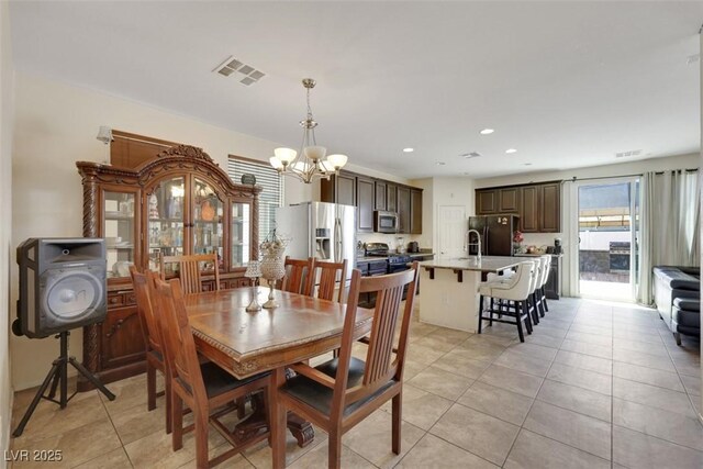 2117 Leatherbridge Ct, North Las Vegas, NV 89081 - dining room with a chandelier, light tile patterned floors, and recessed lighting