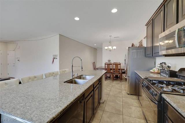 2117 Leatherbridge Ct, North Las Vegas, NV 89081 - kitchen featuring black appliances, a sink, dark brown cabinets, a chandelier, and recessed lighting