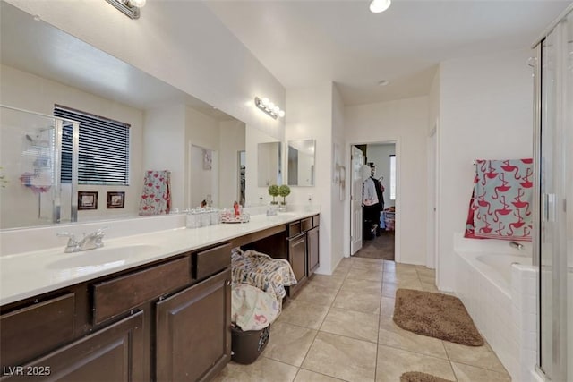 2117 Leatherbridge Ct, North Las Vegas, NV 89081 - full bath with a garden tub, double vanity, tile patterned floors, and a shower stall