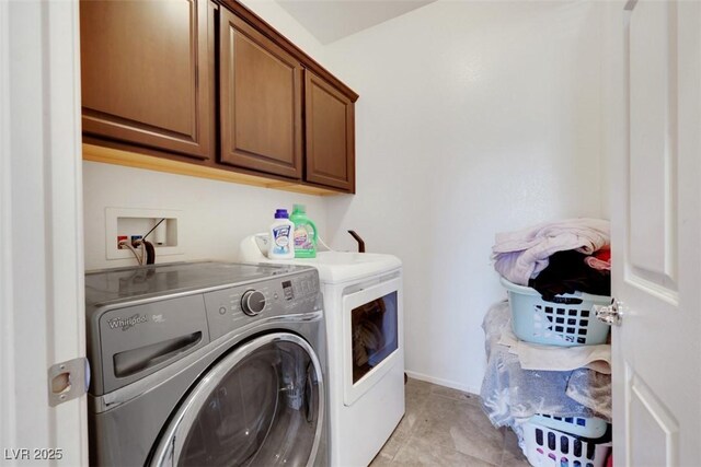 2117 Leatherbridge Ct, North Las Vegas, NV 89081 - washroom featuring washer and clothes dryer, cabinet space, light tile patterned floors, and baseboards