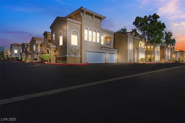 10001 Peace Way Unit 1250, Las Vegas, NV 89147 - townhome / multi-family property with an attached garage, stucco siding, a residential view, and driveway