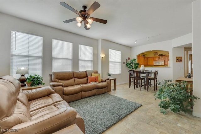 10001 Peace Way Unit 1250, Las Vegas, NV 89147 - living room with a ceiling fan, arched walkways, and baseboards