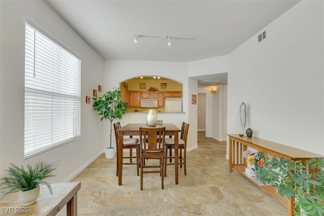 10001 Peace Way Unit 1250, Las Vegas, NV 89147 - dining space featuring track lighting, arched walkways, and baseboards