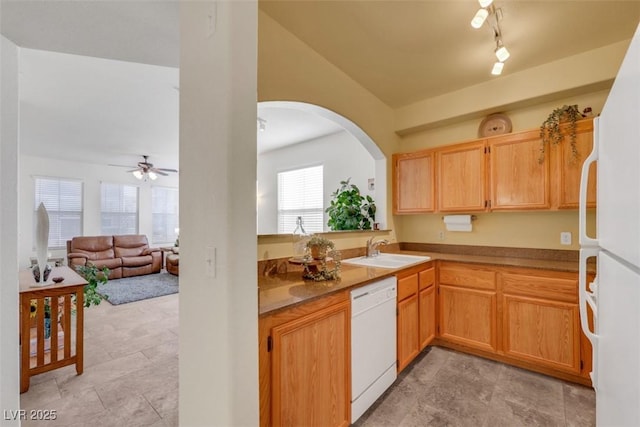 10001 Peace Way Unit 1250, Las Vegas, NV 89147 - kitchen featuring white appliances, a sink, ceiling fan, arched walkways, and open floor plan