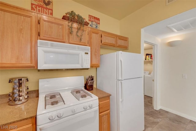 10001 Peace Way Unit 1250, Las Vegas, NV 89147 - kitchen featuring white appliances, light brown cabinets, separate washer and dryer, and light stone counters