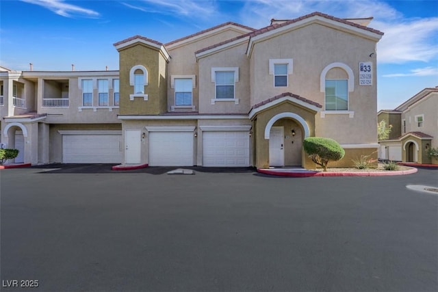 10001 Peace Way Unit 1250, Las Vegas, NV 89147 - multi unit property with stucco siding, an attached garage, and driveway