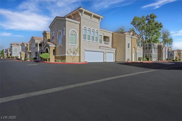 10001 Peace Way Unit 1250, Las Vegas, NV 89147 - view of building exterior featuring a residential view, an attached garage, and driveway