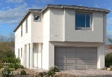 11881 Pied Harrier Ave, Las Vegas, NV 89138 - view of front of property featuring stucco siding, a garage, and driveway
